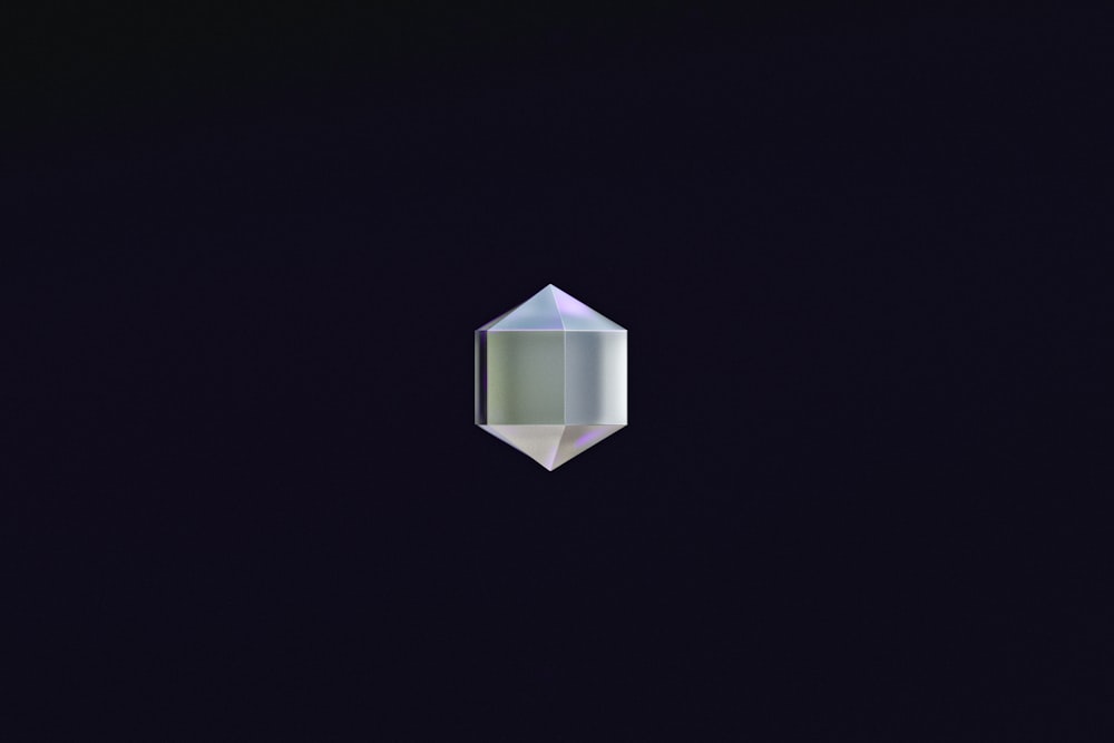 a diamond shaped object in the middle of a dark background