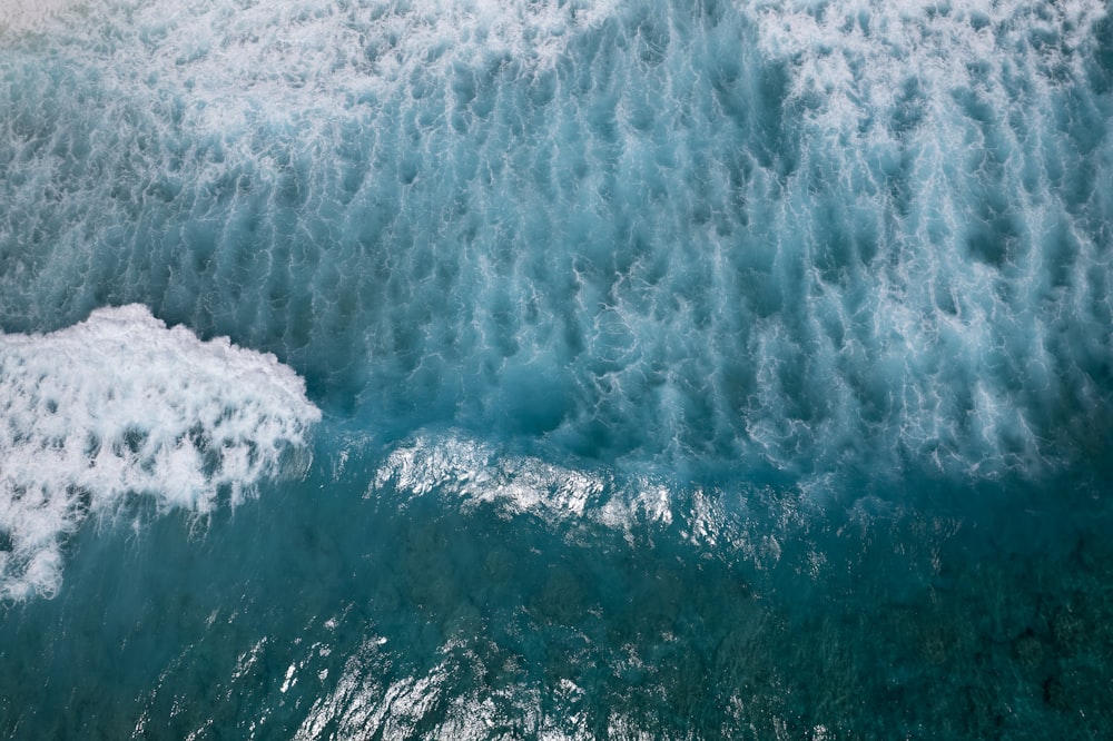 an aerial view of the ocean with waves