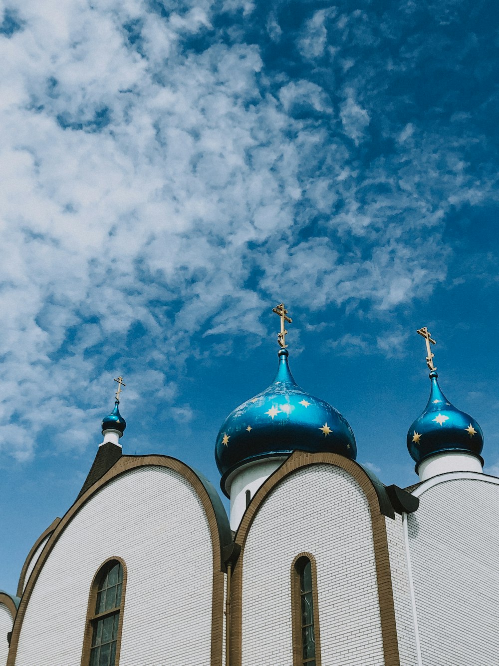 a large white building with two blue domes