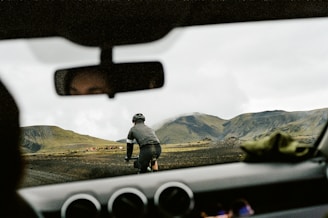 a man riding a bike down a dirt road