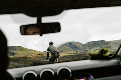a man riding a bike down a dirt road