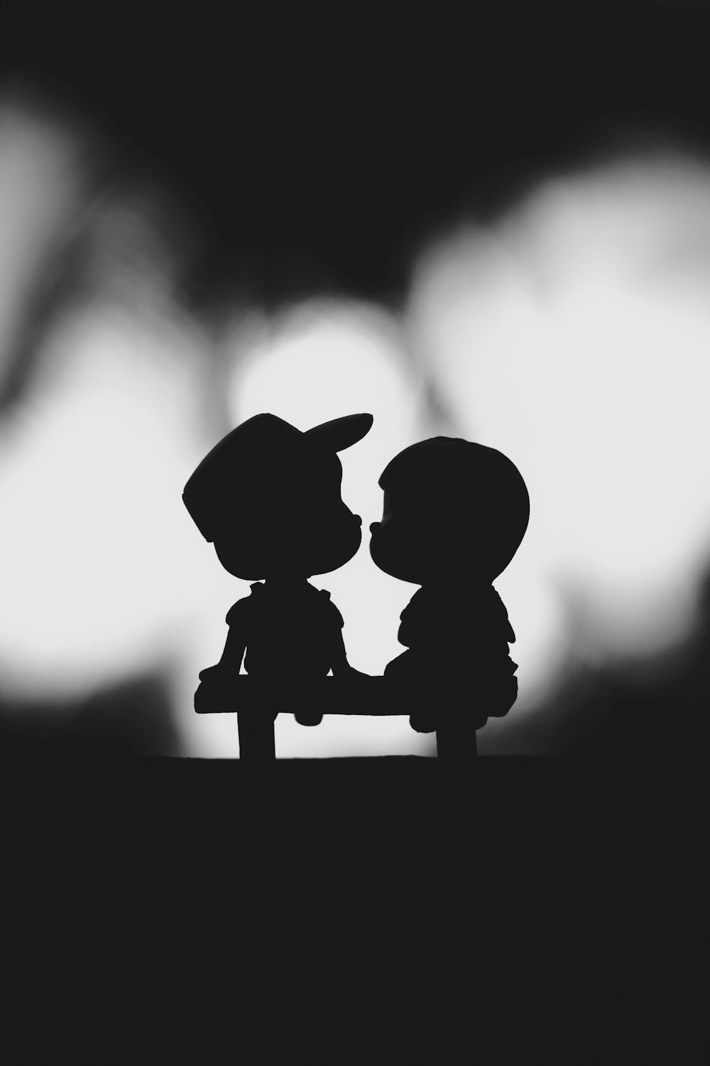 a couple of small figurines sitting next to each other