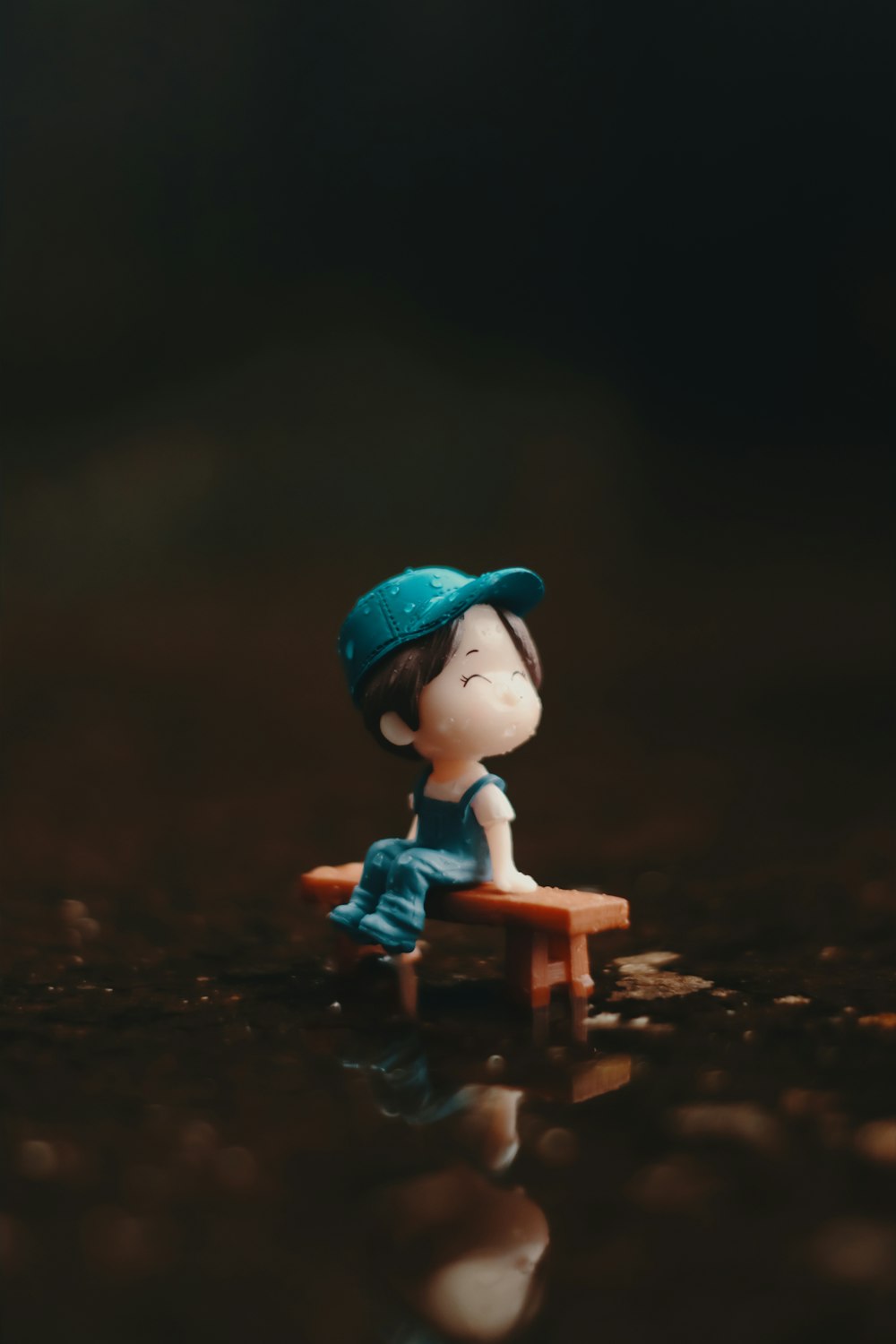 a small figurine of a person sitting on a bench