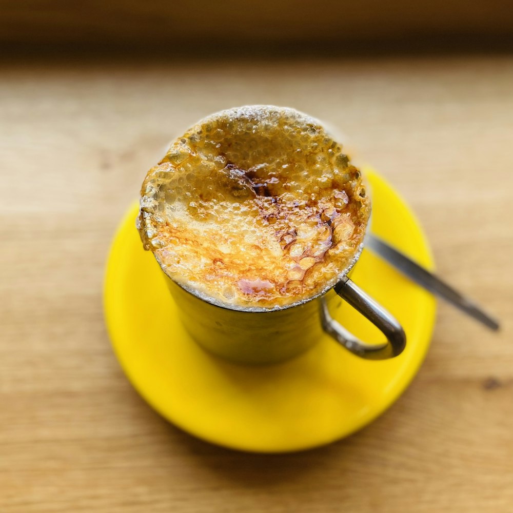 a cup of coffee on a yellow saucer