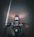 a person riding a motorcycle on a dark street