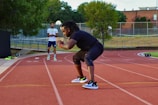 two people on a track with a tennis racket