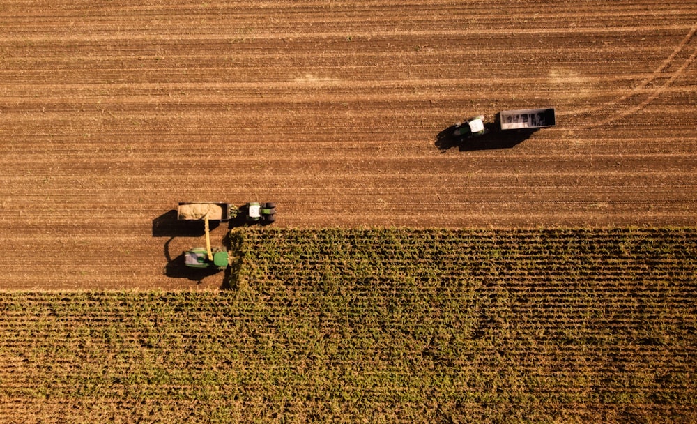 a tractor and a tractor trailer in a field