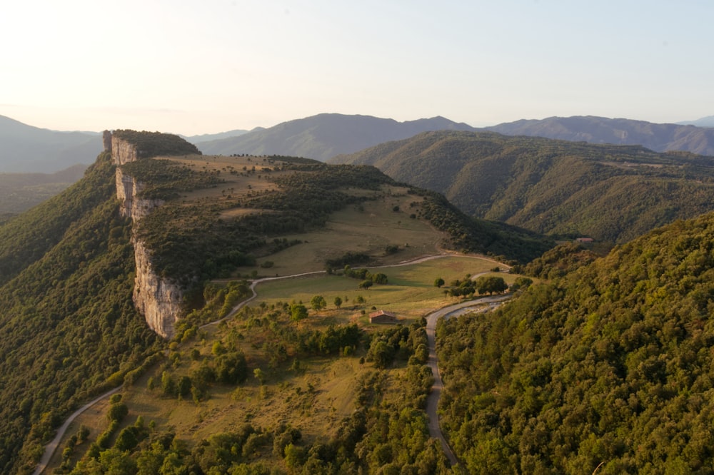 an aerial view of a mountain with a winding road