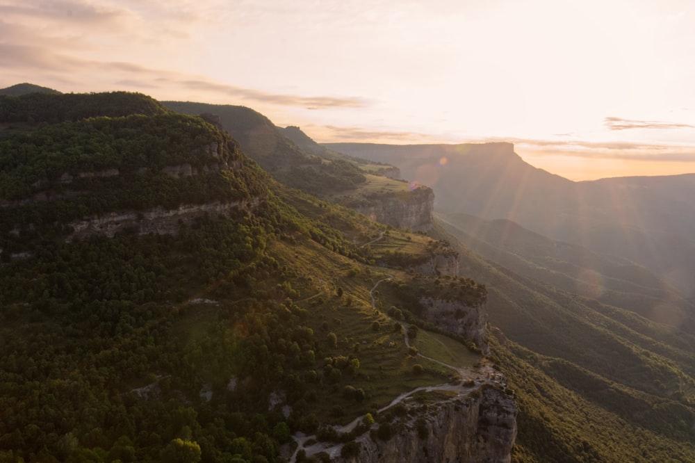 a scenic view of a valley with mountains in the background