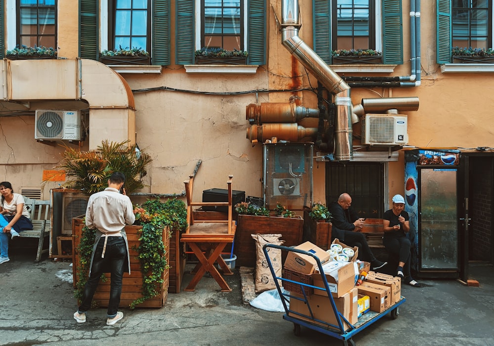 a group of people sitting outside of a building