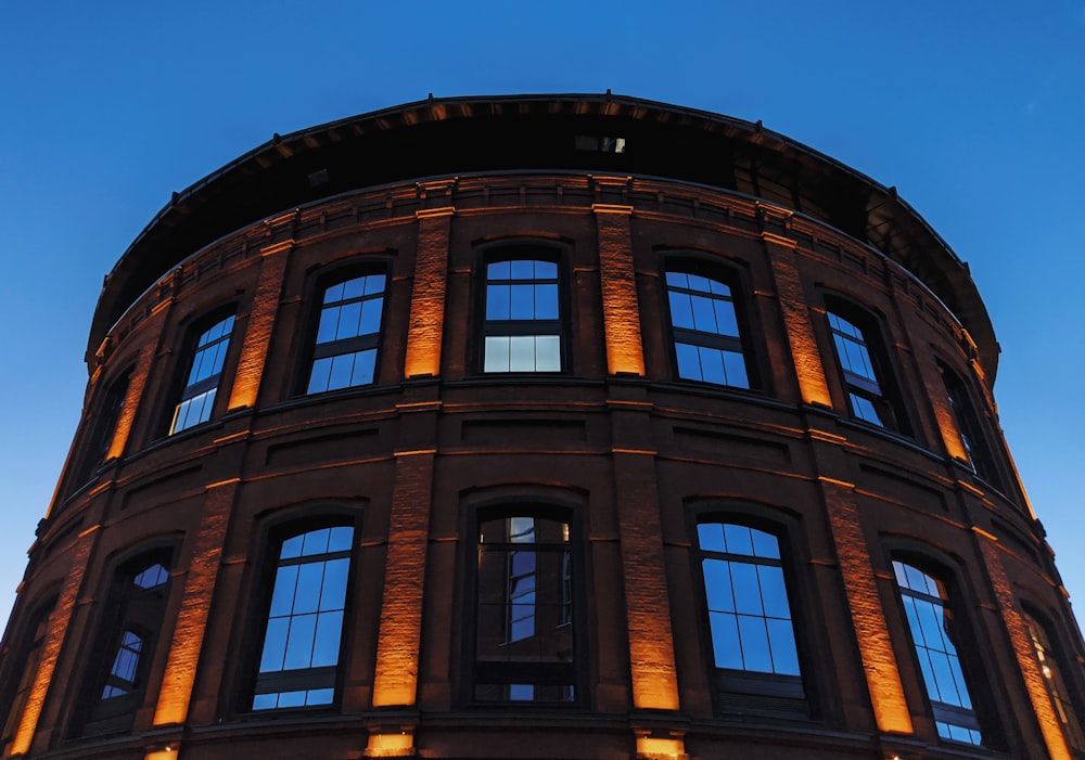 a tall building with lots of windows lit up at night