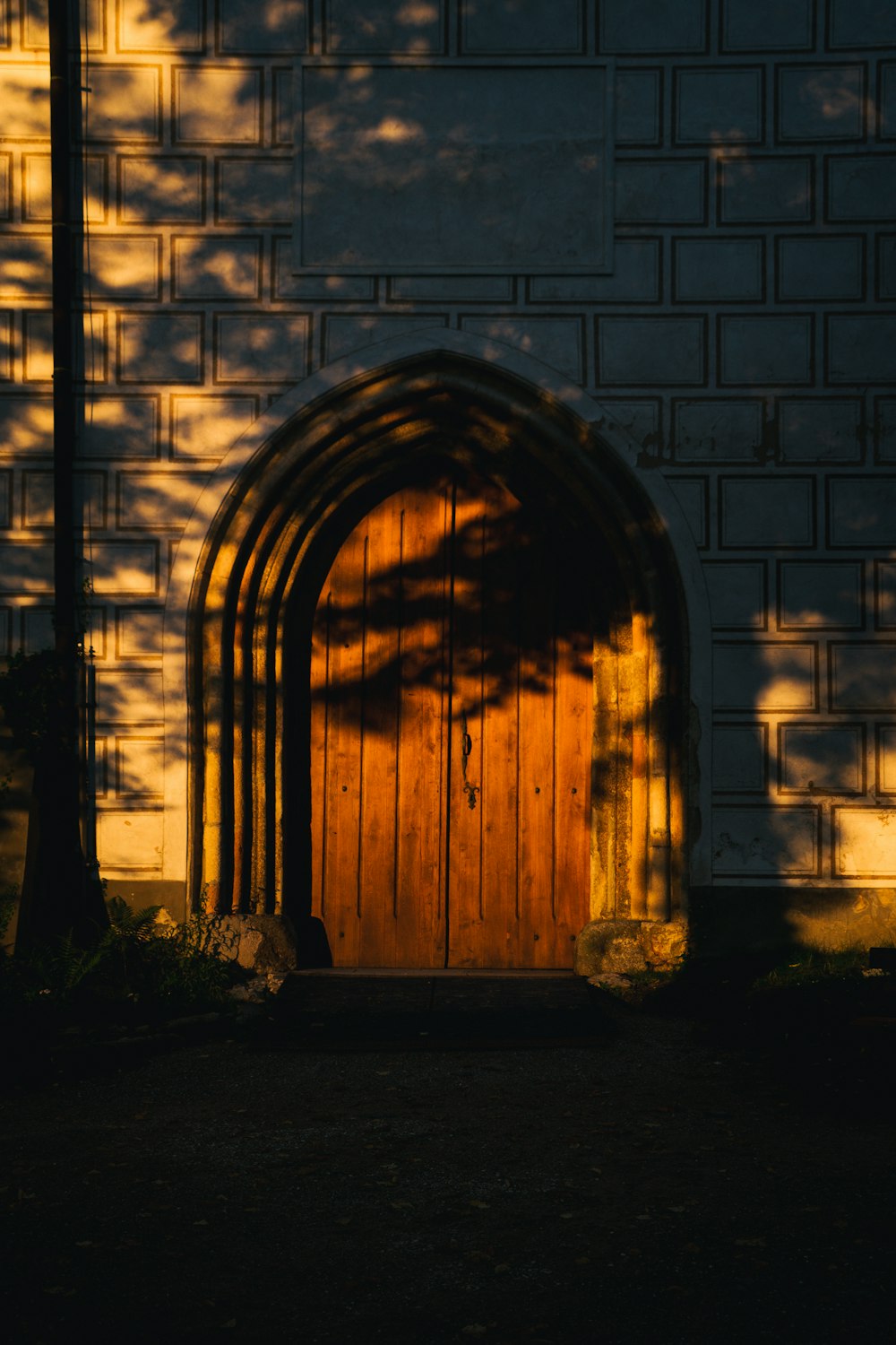 a large wooden door in front of a brick building