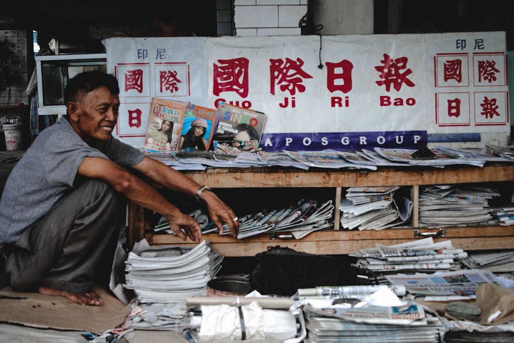 a man sitting in front of a pile of papers