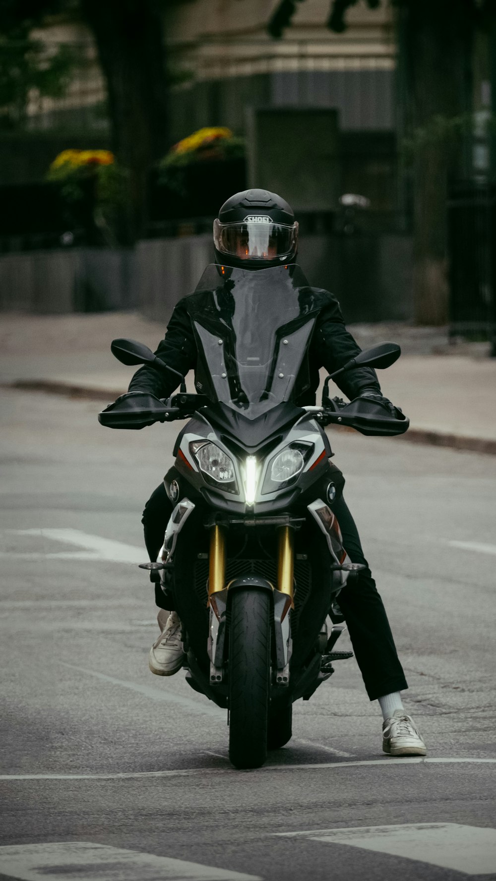 a man riding a motorcycle down a street