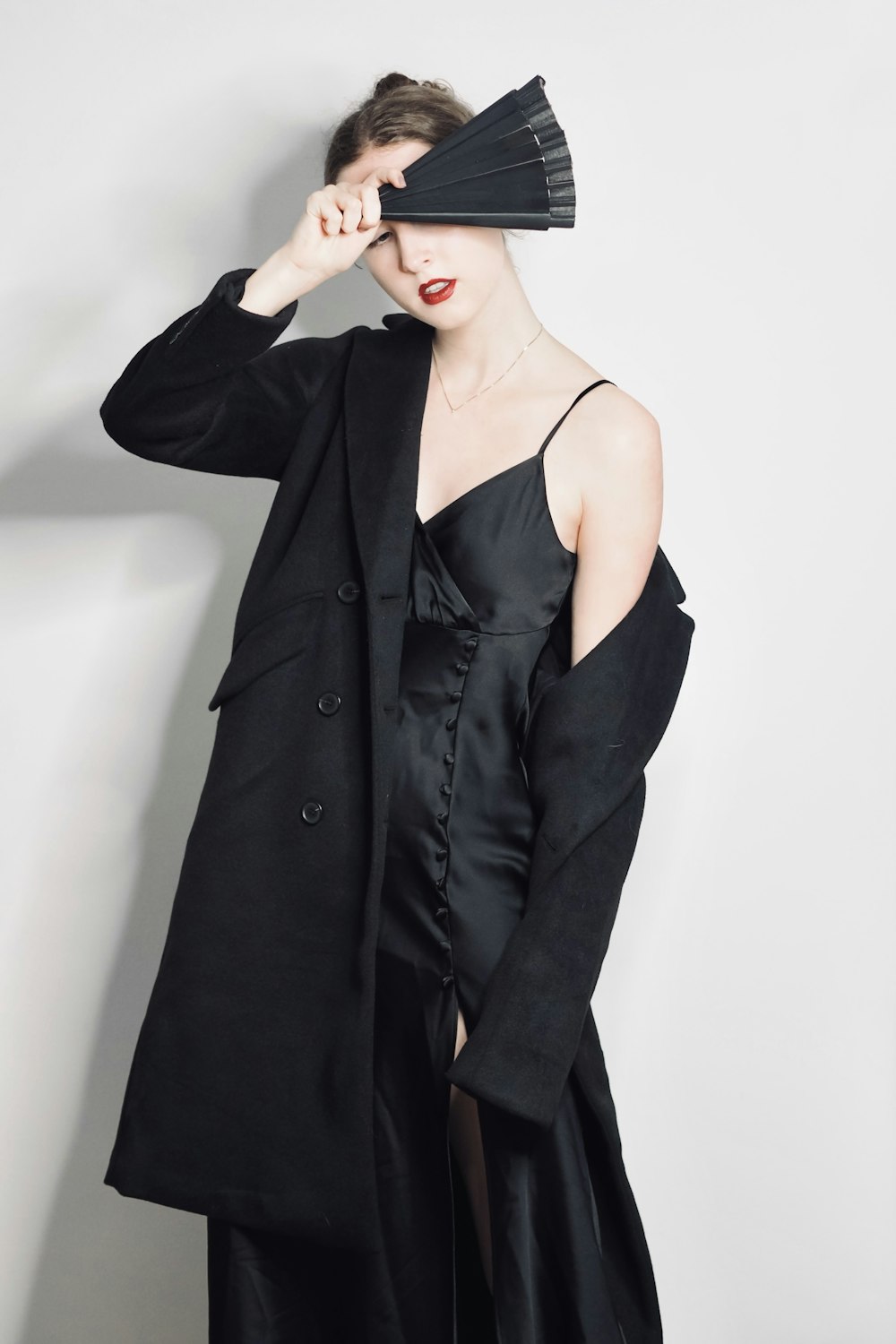 a woman in a black dress and a black hat
