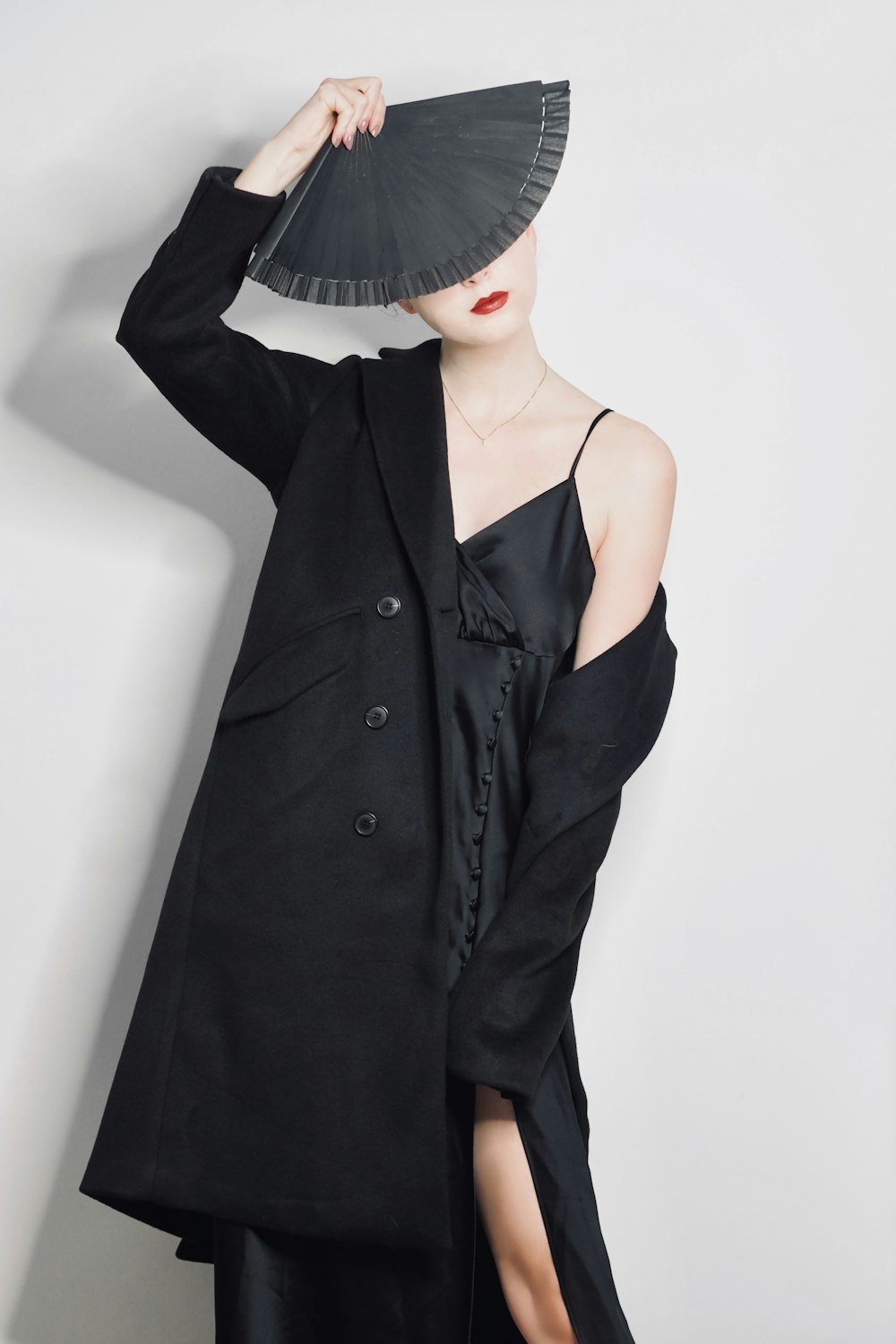 a woman in a black dress and a black hat