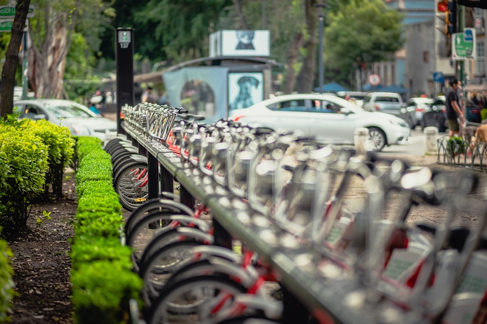 a row of bikes parked next to each other on a sidewalk