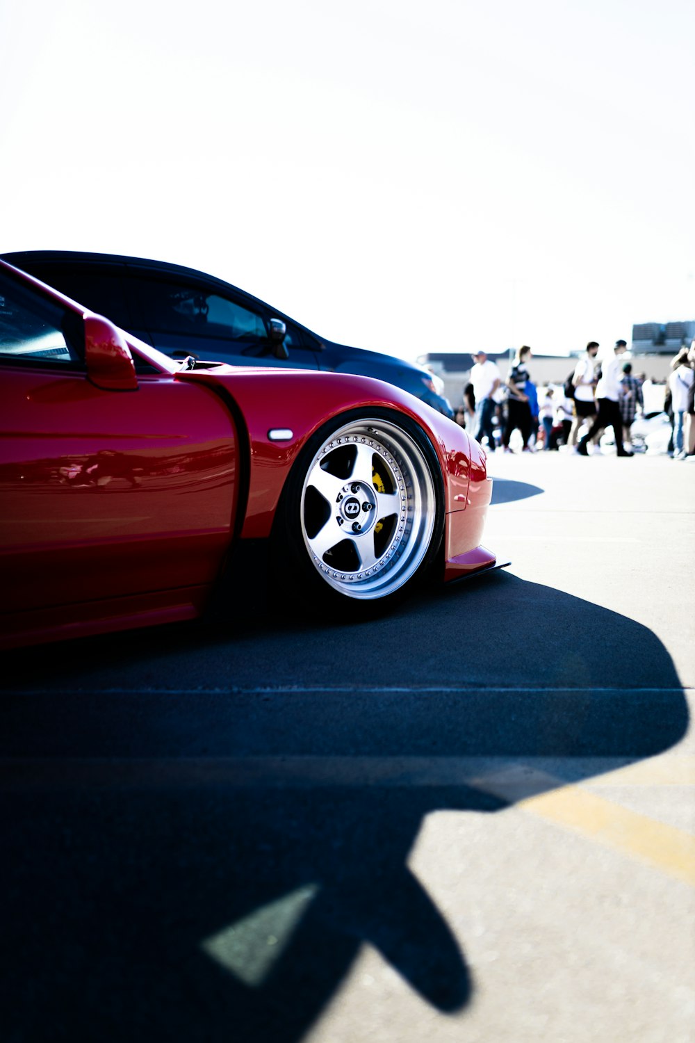 a red sports car parked in a parking lot