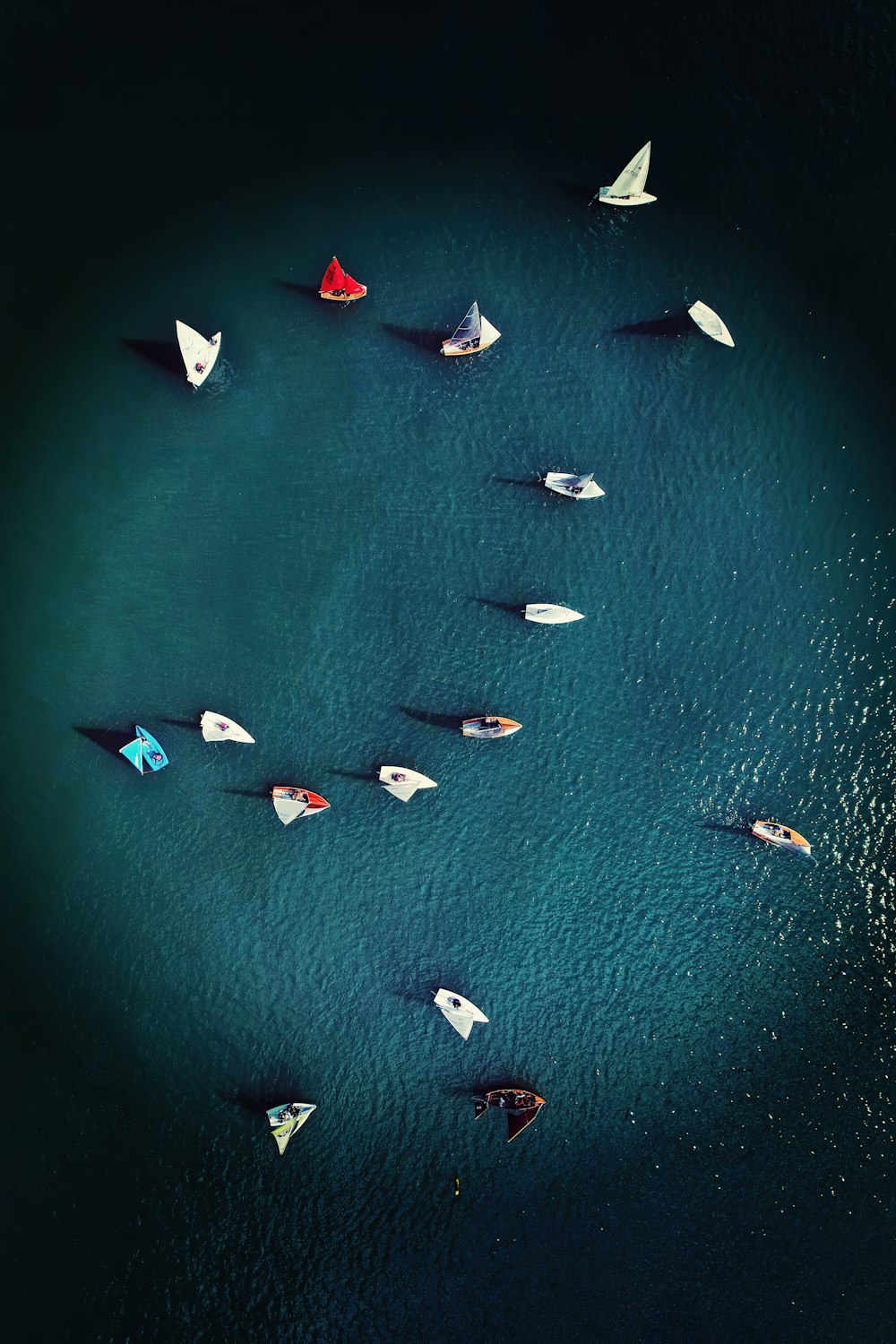 a group of boats floating on top of a body of water