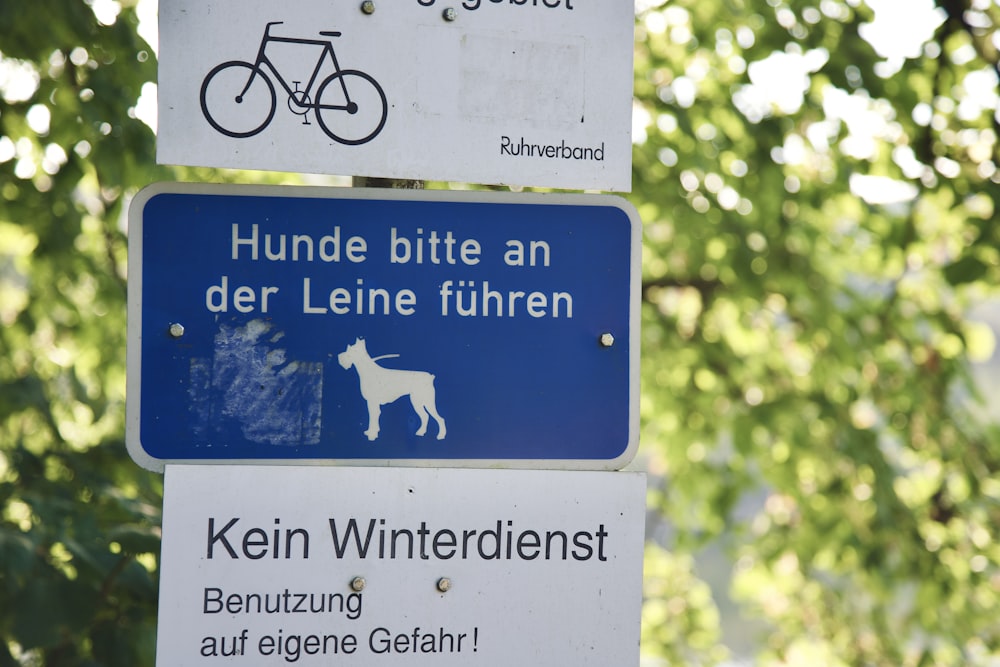 a street sign with a dog and a bicycle on it