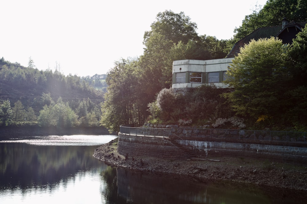 a body of water surrounded by trees and a building