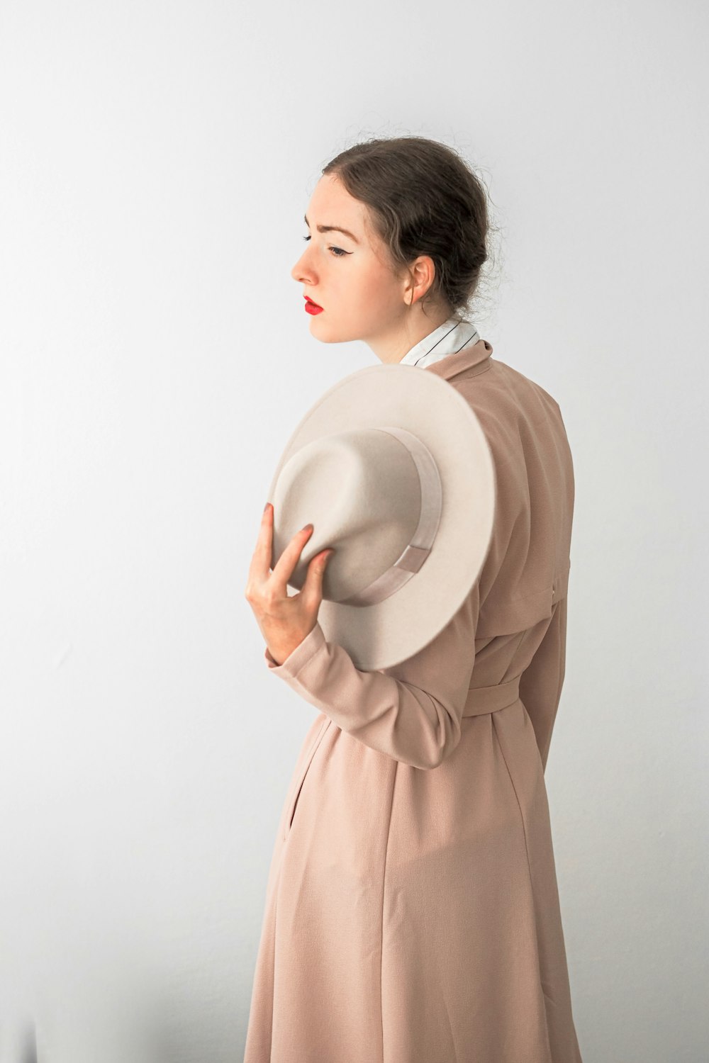 a woman in a dress and a hat