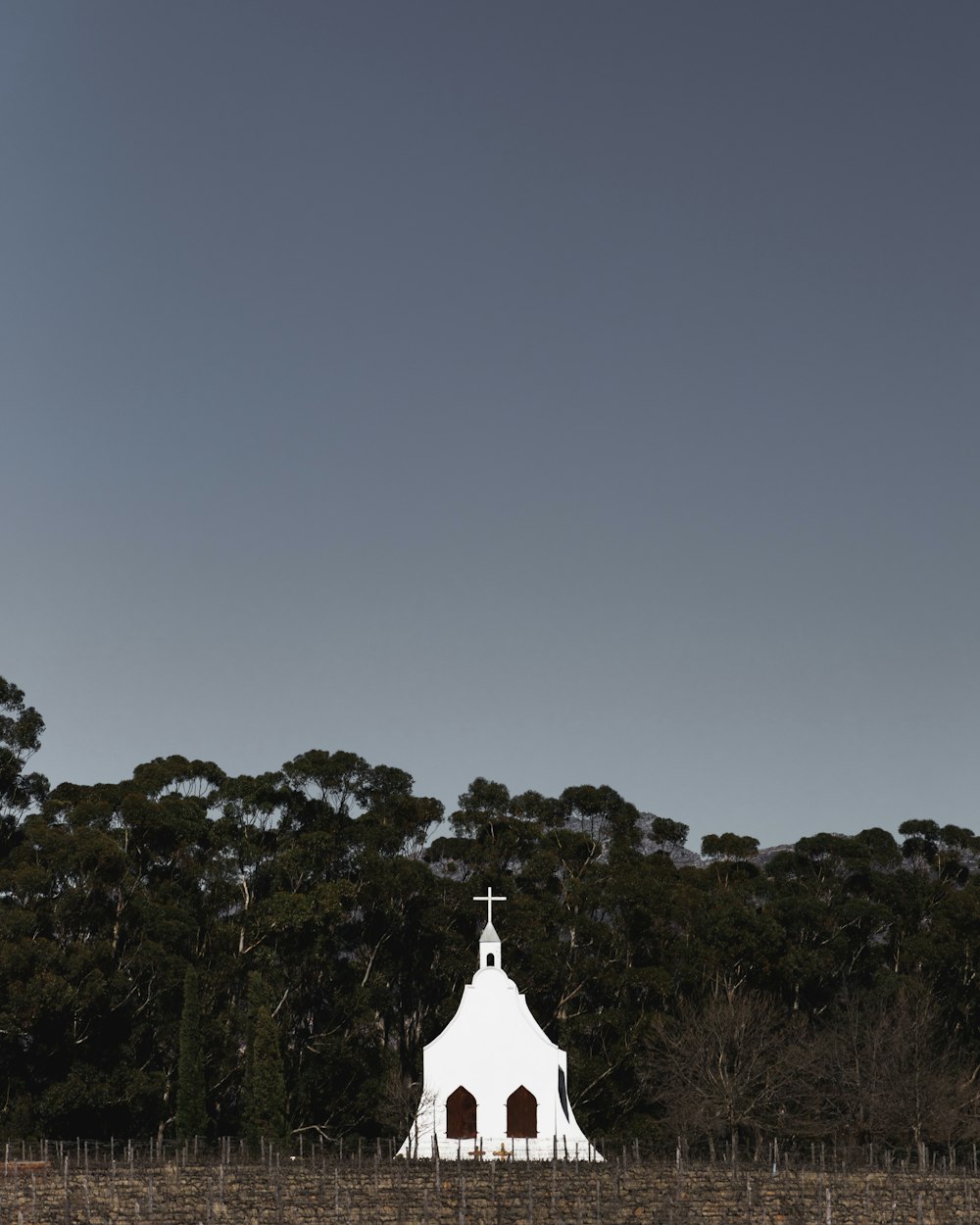 a white church with a cross on top of it