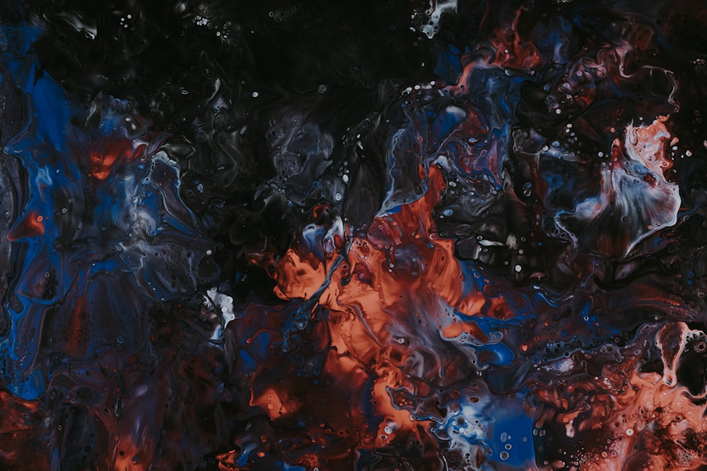 an abstract painting of red, blue, and black