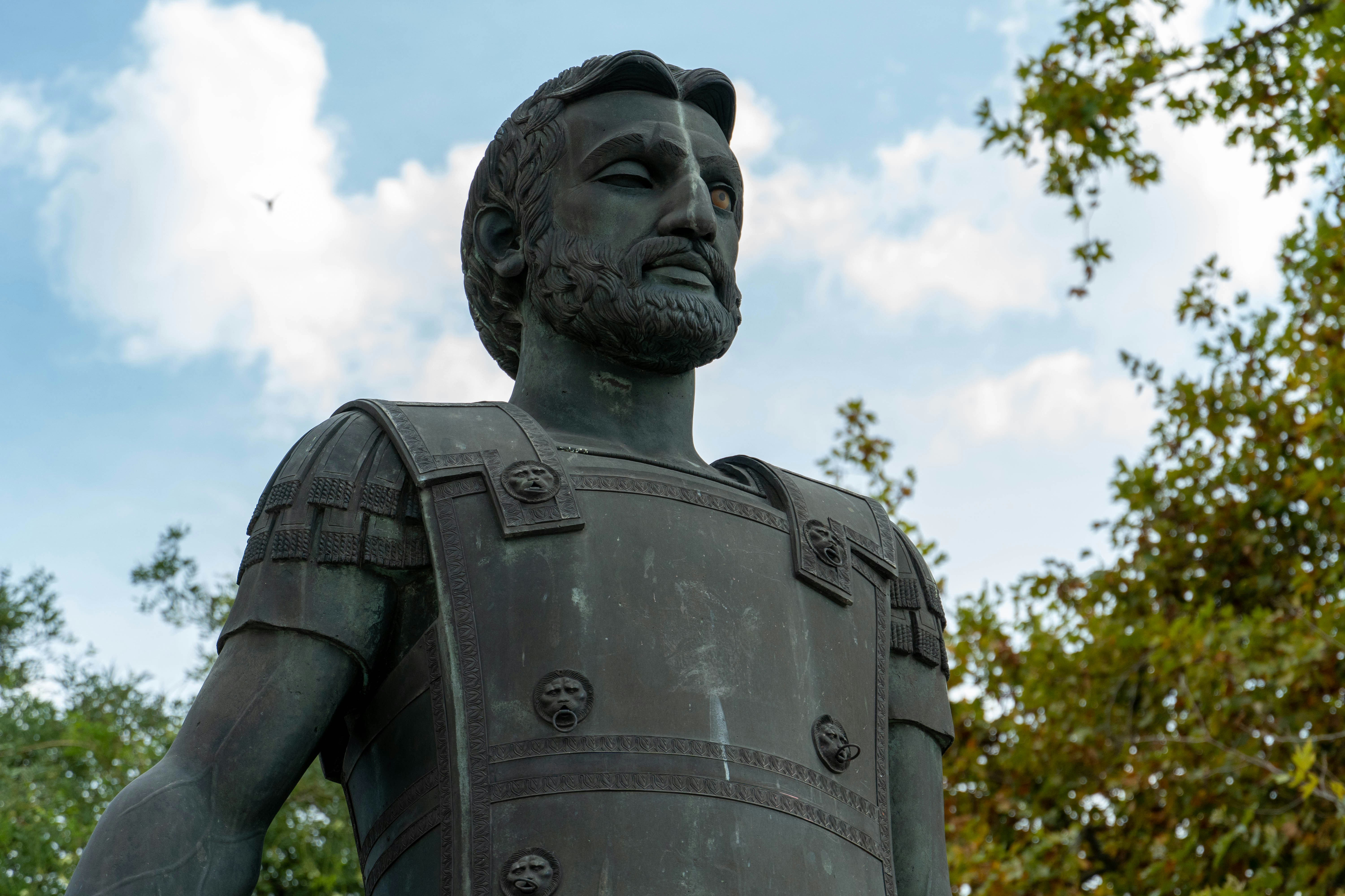 A statue of a roman soldier with a beard photo Free Sculpture Image