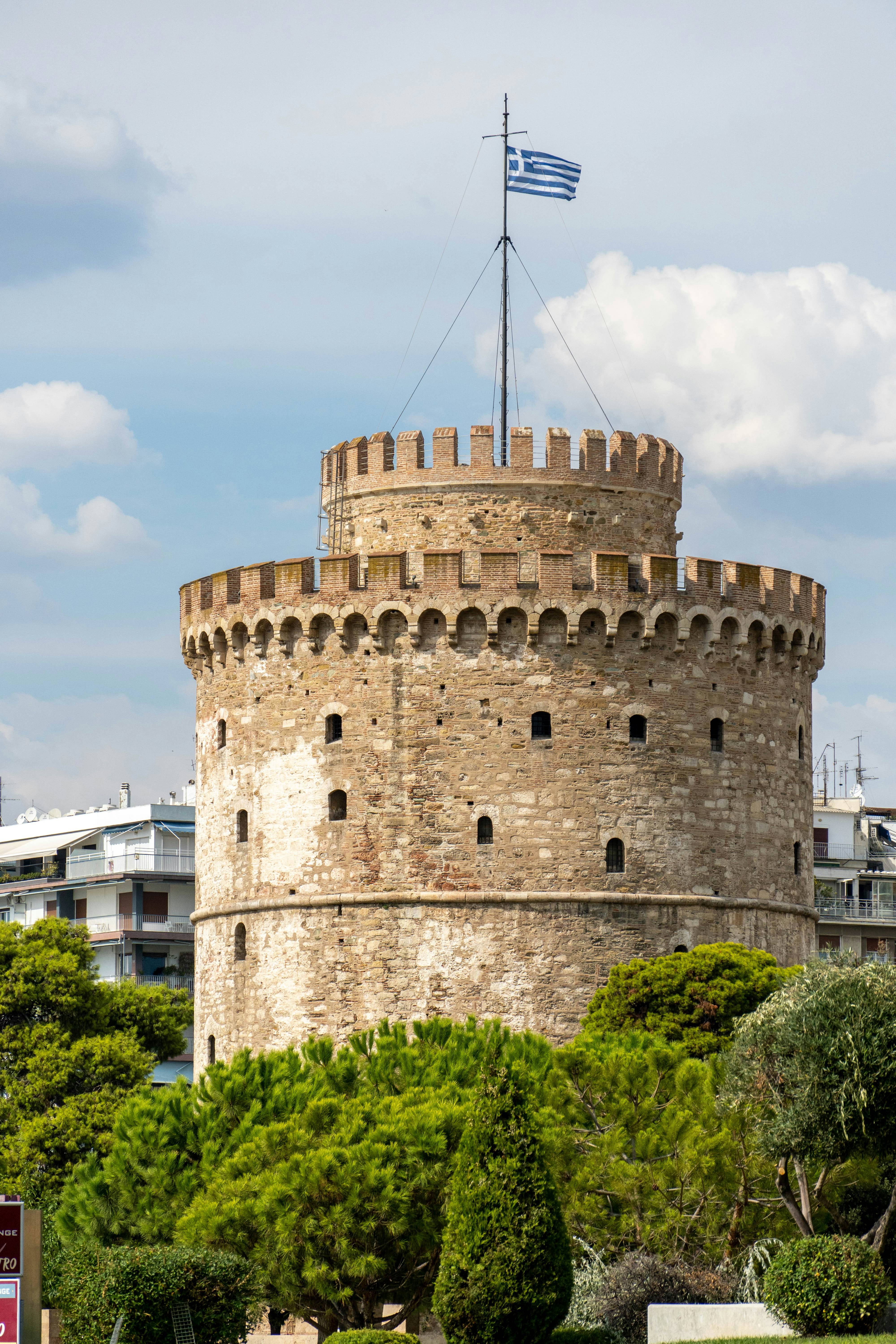 a tall tower with a flag on top of it
