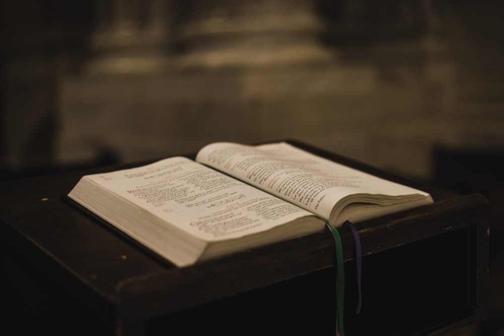 an open book sitting on top of a wooden table