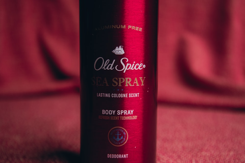 a bottle of old spice sea spray sitting on a bed