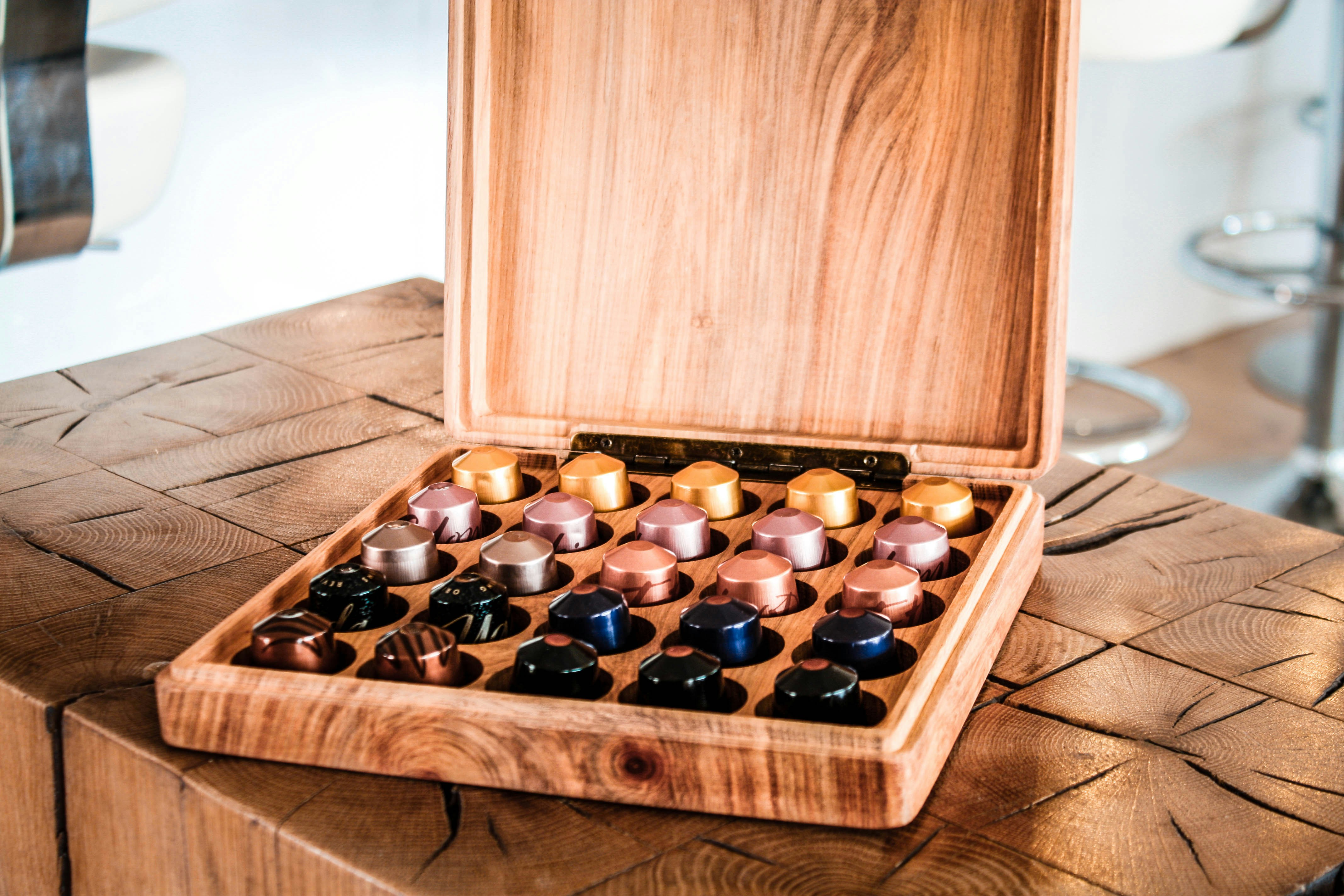 a wooden box filled with lots of different colored rocks