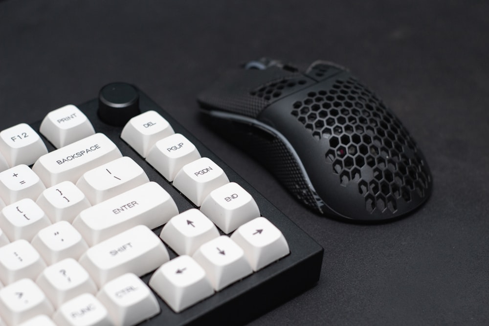 a computer keyboard and a mouse on a table