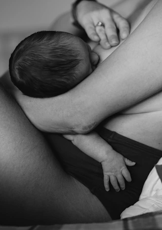 Close-up image of a mother holding her baby, representing paediatrics.