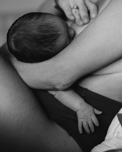 Close-up image of a mother holding her baby, representing paediatrics.