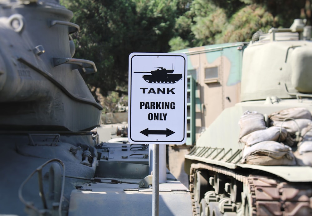 a tank parking only sign next to a tank