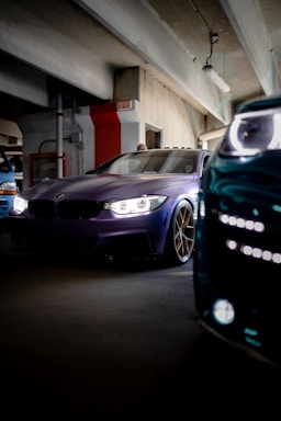 two cars parked in a parking garage next to each other