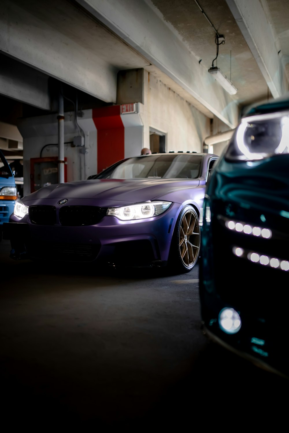 two cars parked in a parking garage next to each other