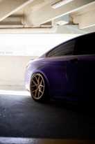 a purple car parked in a parking garage