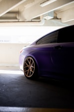 a purple car parked in a parking garage