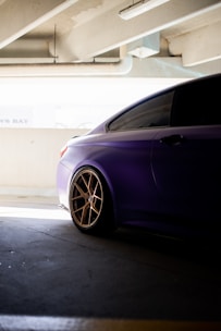 a purple car parked in a parking garage