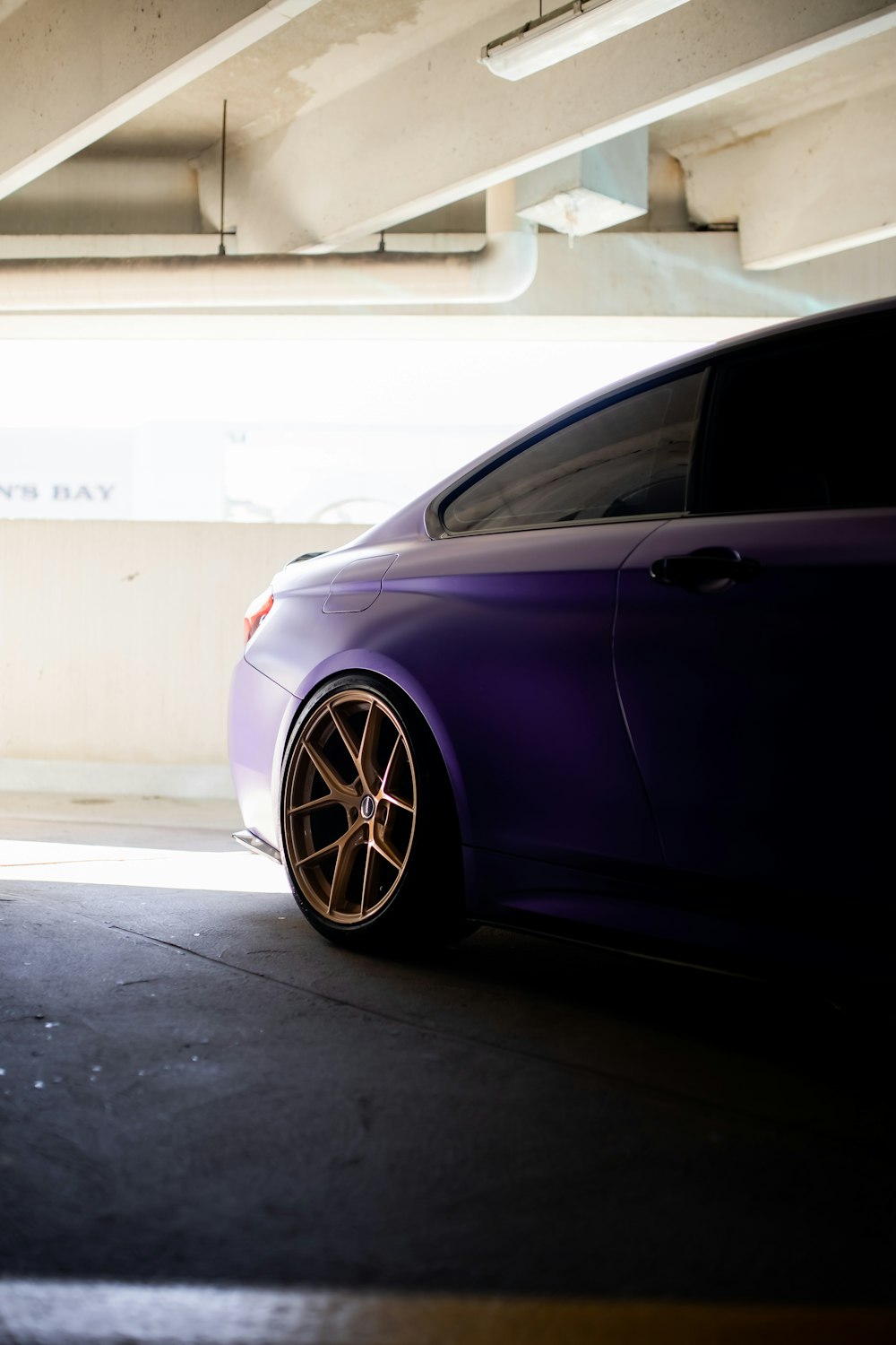 a purple car parked in a parking garage