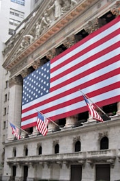a building with a large american flag on the side of it