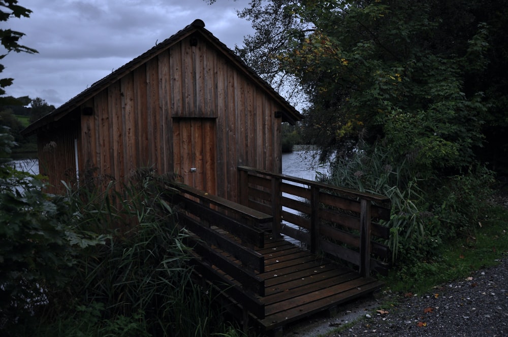 a small wooden building sitting next to a body of water