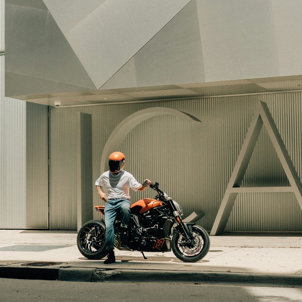 a man sitting on a motorcycle in front of a building