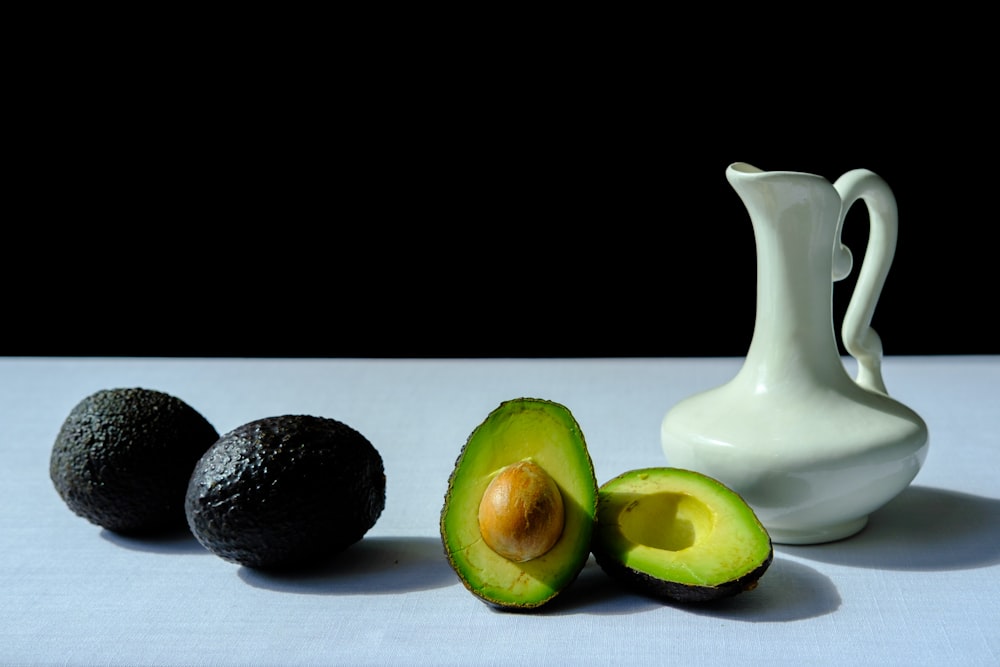 an avocado, an avocado slice, and an avocado