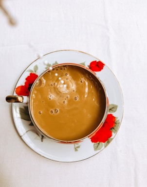 A vibrant display of six colorful milk tea cups with toppings on a wooden table.