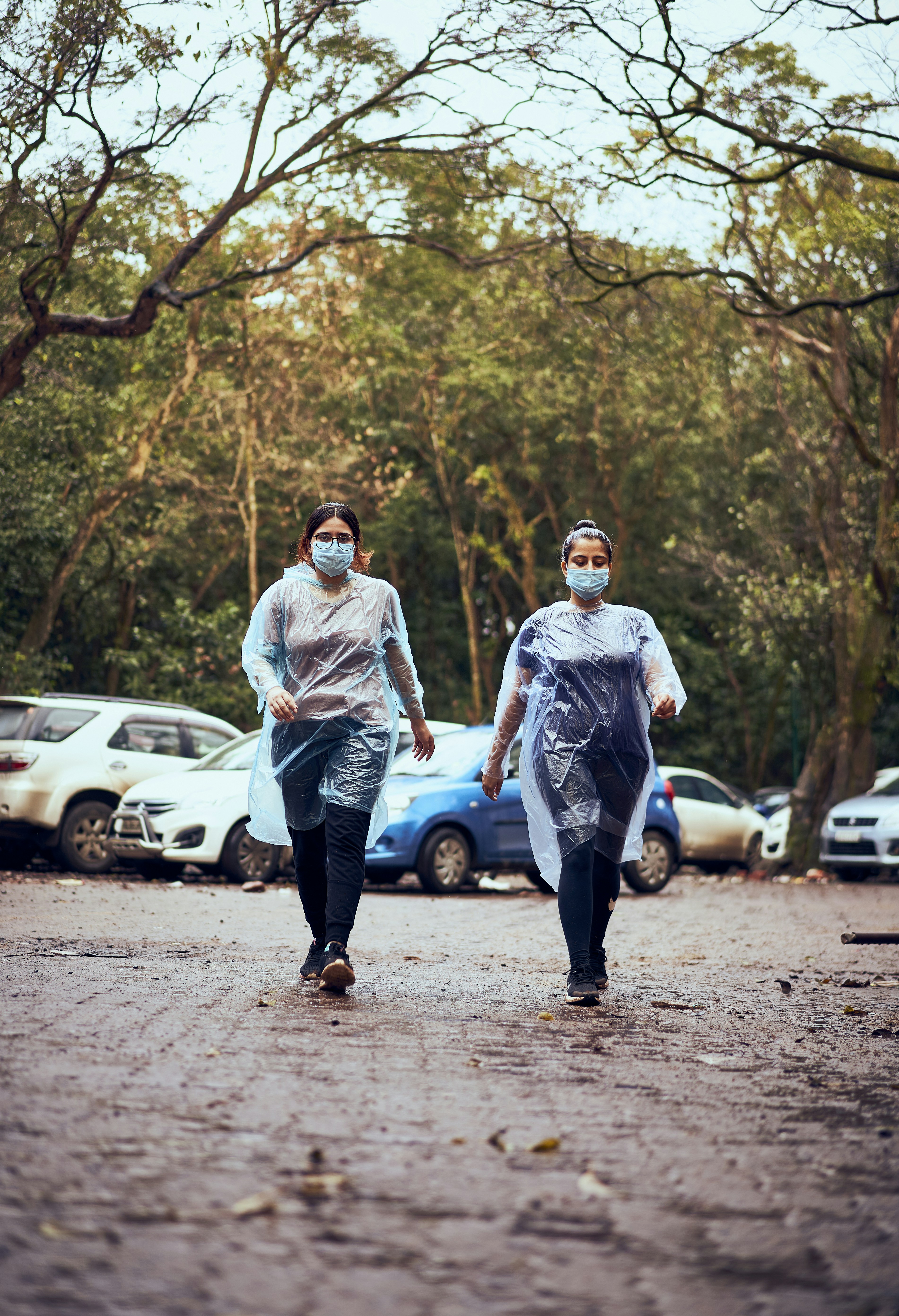 a couple of people walking down a dirt road