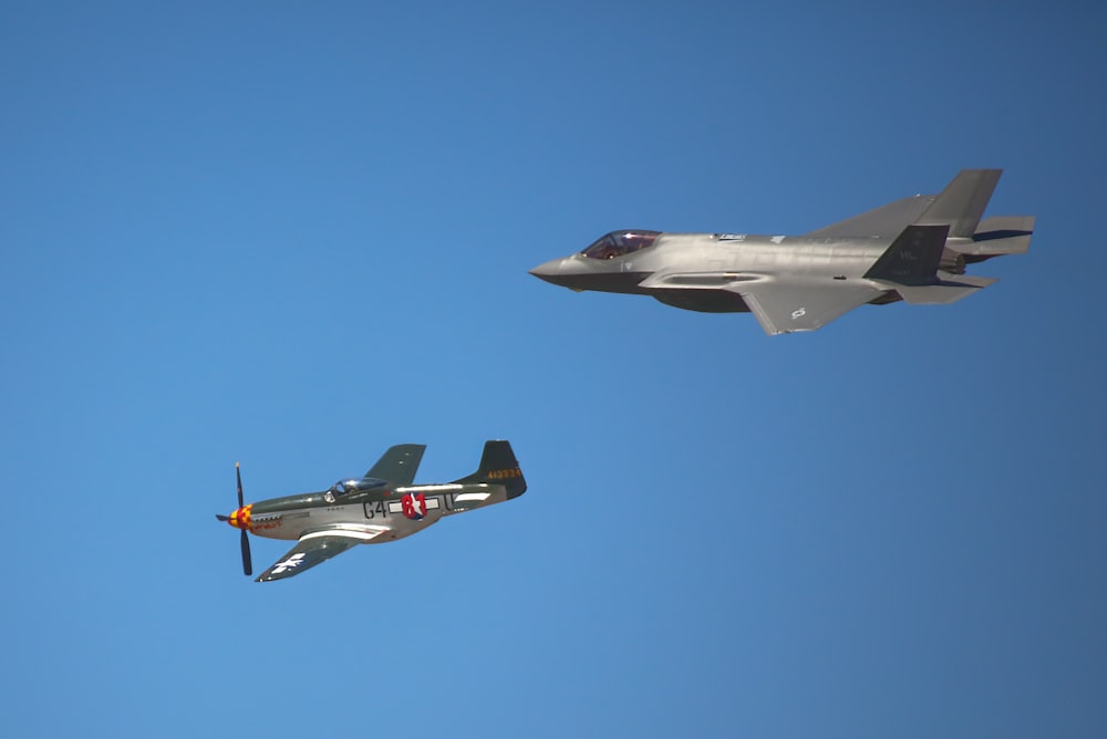 two planes flying side by side in the sky